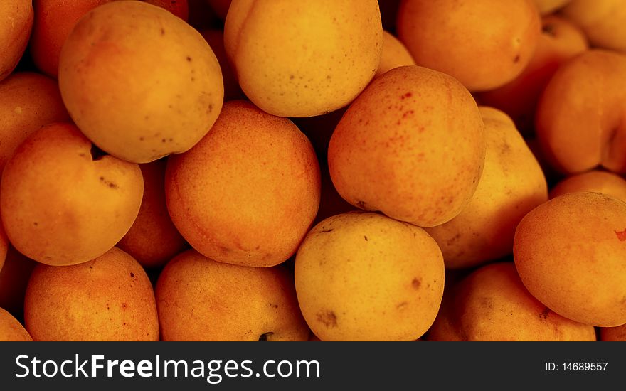 Closeup of a bunch of yellow apricots