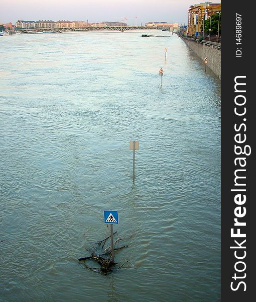 Traffic signs in a flooded street. Flood waters in a city.