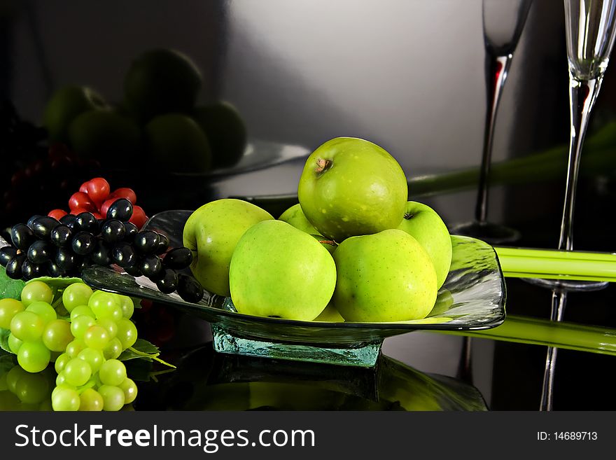Composition with grapes and apples in dark background