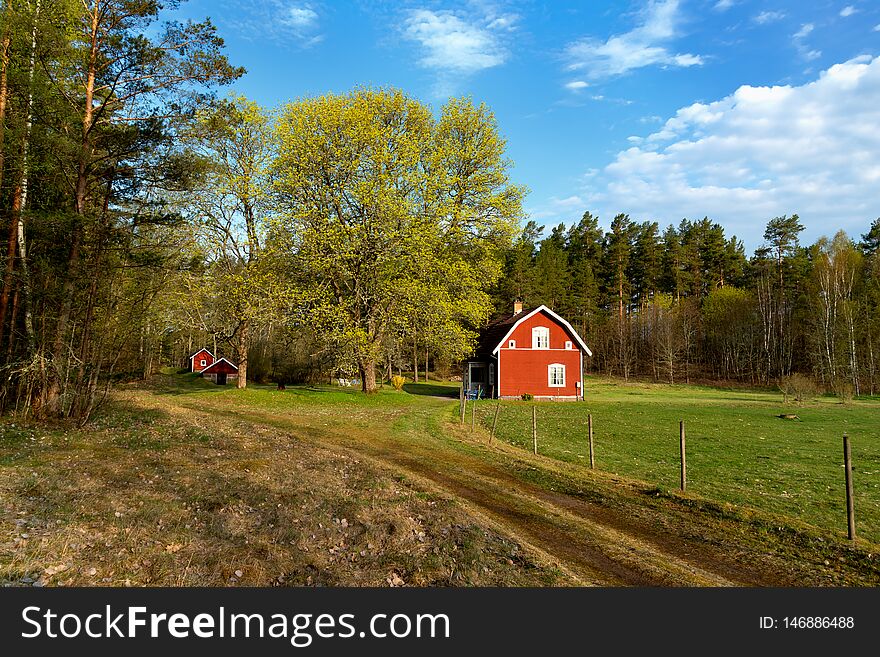 Typical red wooden cottage in Sweden in spring. Smaland, south-east Sweden. Typical red wooden cottage in Sweden in spring. Smaland, south-east Sweden