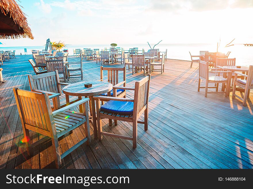 Summer empty open air cafe at exotic island at sunset. Summer empty open air cafe at exotic island at sunset