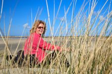 Woman Sitting In The Sand Dunes On The Beach Stock Photography Woman Sitting In The Sand Dunes On The Beach Stock Photography