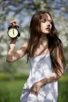 Young Girl With An Alarm Clock In The Meadow Stock Photography Young Girl With An Alarm Clock In The Meadow Stock Photography