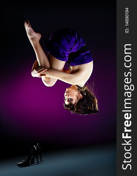 The portrait of a beautiful lady wearing a violet dress and zero gravity. The portrait of a beautiful lady wearing a violet dress and zero gravity