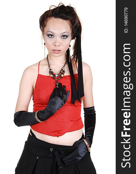 A young Chinese punk woman with black cloves and skirt and red top
standing in the studio holding on to her necklace, on white background. A young Chinese punk woman with black cloves and skirt and red top
standing in the studio holding on to her necklace, on white background.