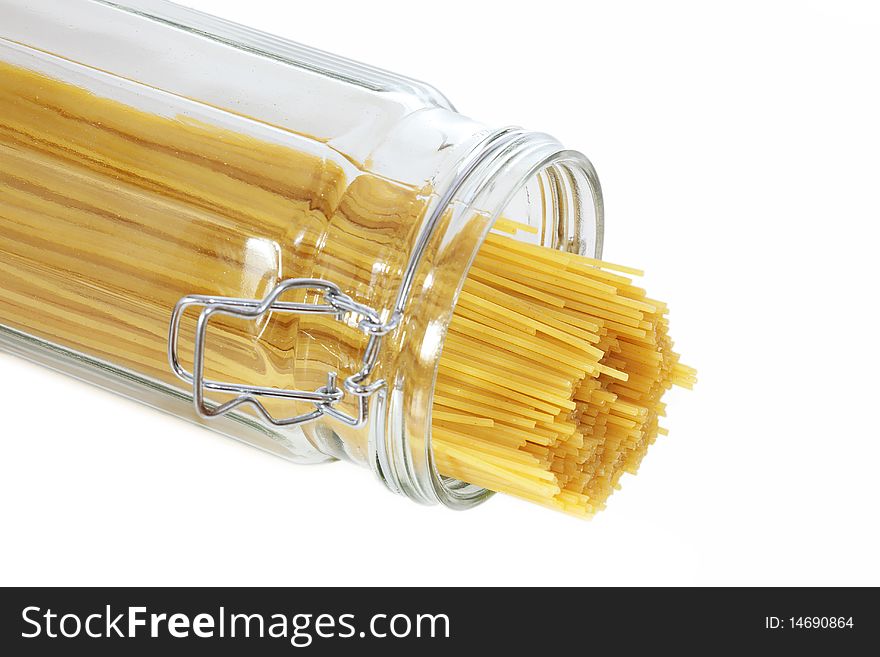 Spaghetti Pasta sticking out of a glass jar, isolated on a white background