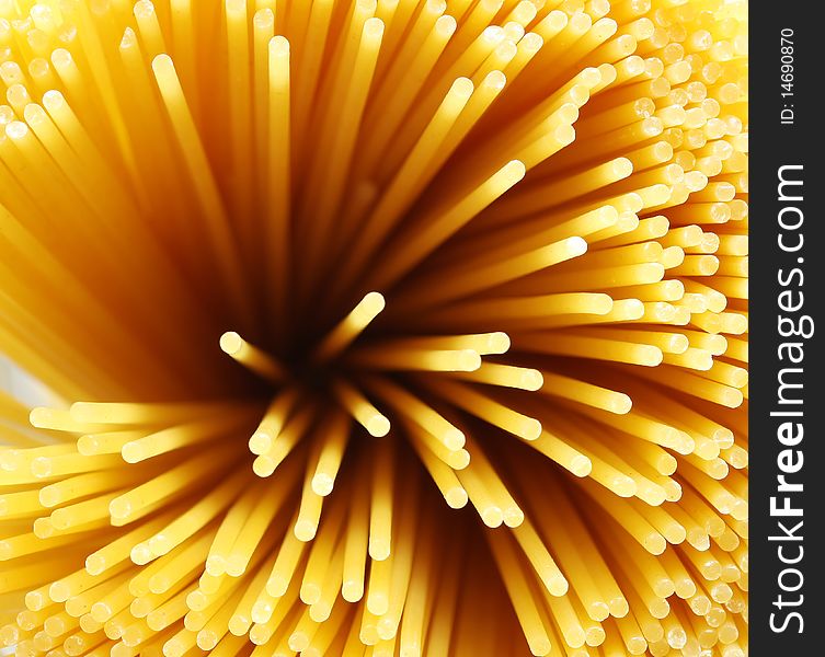 Closeup looking down the length of spaghetti noddles. Closeup looking down the length of spaghetti noddles