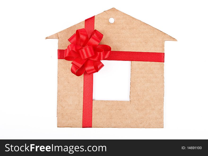 Cardboard house with red ribbon and bow