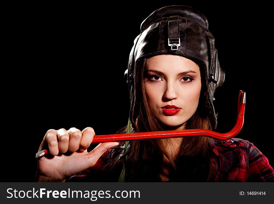 Young beautiful woman in cell shirt with red crowbar. Young beautiful woman in cell shirt with red crowbar