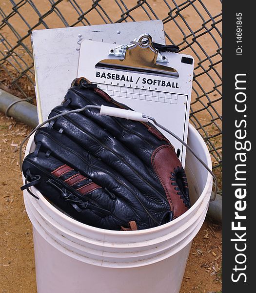 Bucket of baseball equipment belonging to the coach. Bucket of baseball equipment belonging to the coach