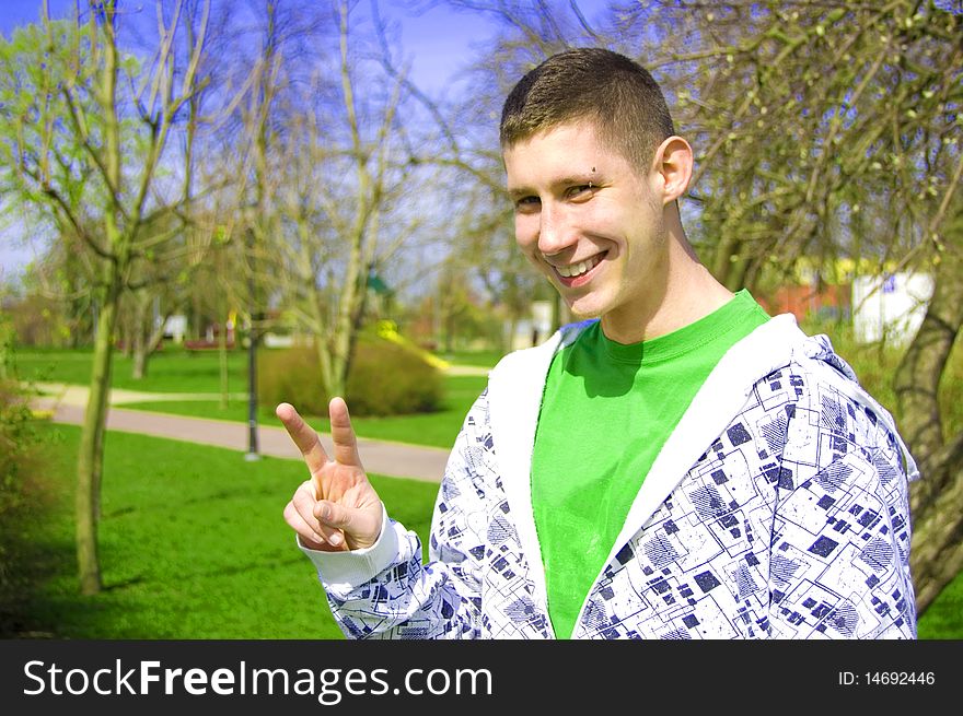 Teenager conceptual image. Teenager giving the youth sign.