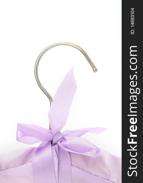 A silk clothes hanger with a bow on a white background