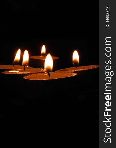 Burning candles on a dark background with warm light