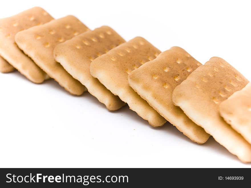 Group of a delicious sweet biscuits, lying one on another in a row, isolated on a white background. Group of a delicious sweet biscuits, lying one on another in a row, isolated on a white background