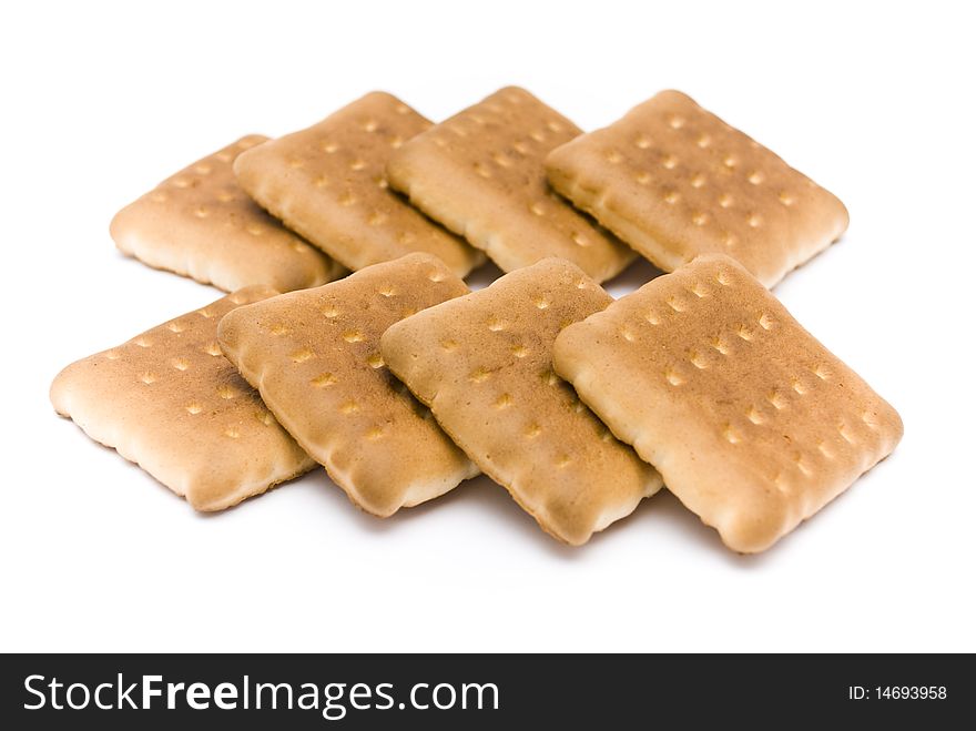 Group of a delicious sweet biscuits, lying one on another in a row, isolated on a white background