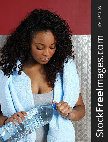 Woman Fitness Trainer In The Gym With Bottle