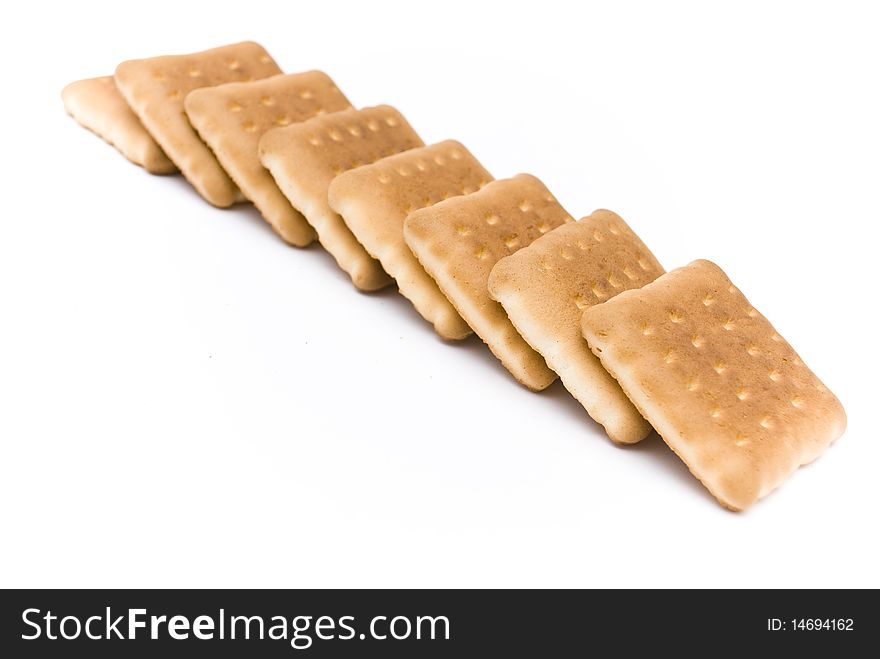 Group of a delicious sweet biscuits, lying one on another in a row, isolated on a white background