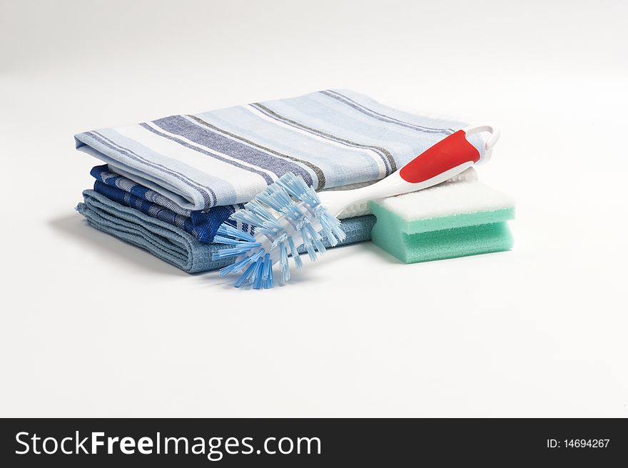 A Washing Up Brush, Scouring Pad and Three Folded Drying Cloths. A Washing Up Brush, Scouring Pad and Three Folded Drying Cloths