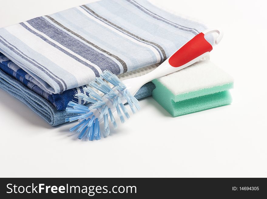 A Washing Up Brush, Scouring Pad and Three Folded Drying Cloths. A Washing Up Brush, Scouring Pad and Three Folded Drying Cloths