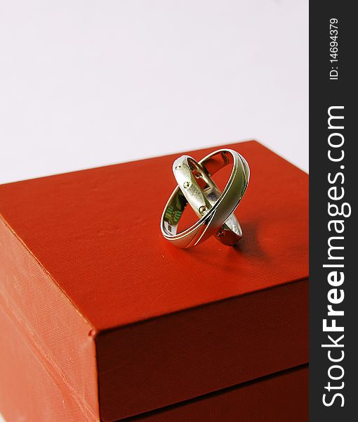 Wedding rings on a red box isolated on white backrground