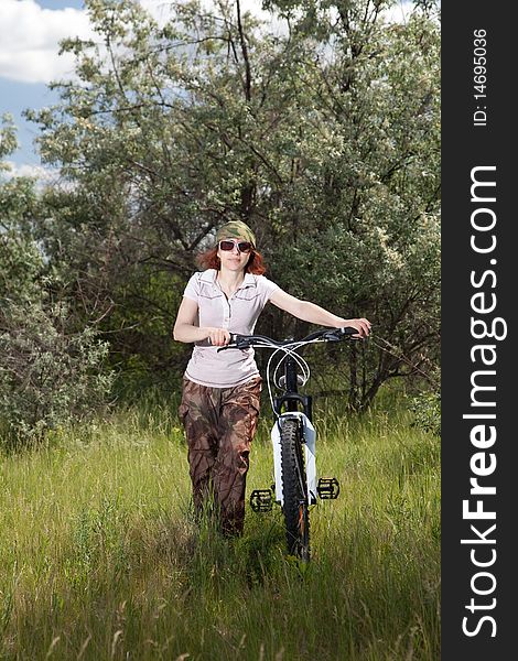 Woman riding bike in countryside