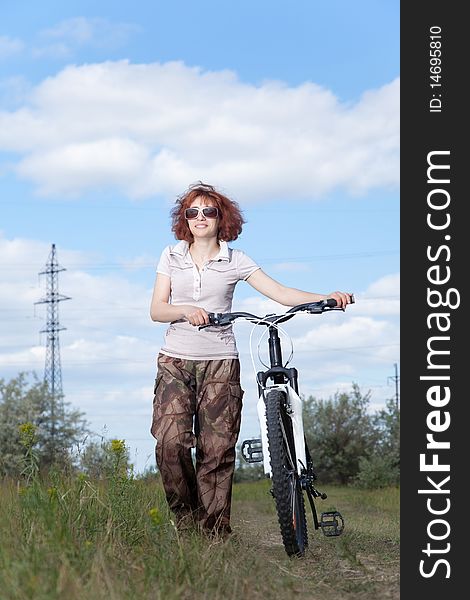 Woman riding bike in countryside