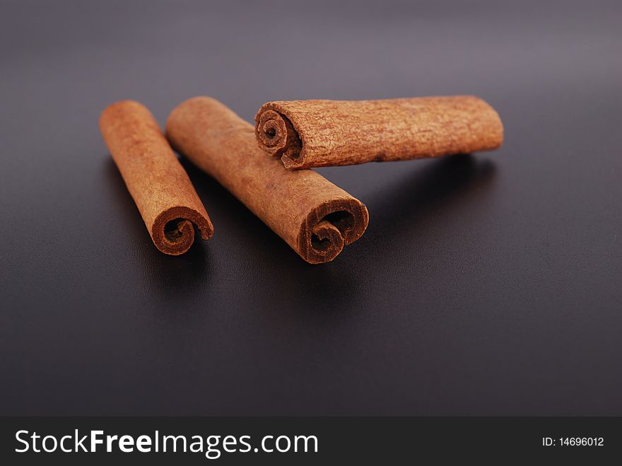 Two cinnamon sticks isolated on black background. Close up.