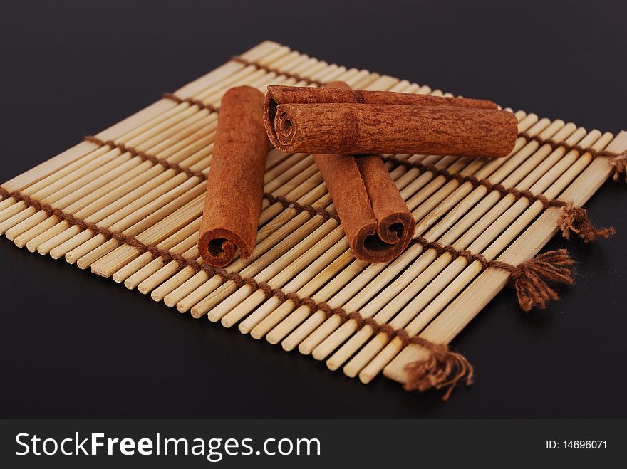 Sticks cinnamon on a laying from a bamboo