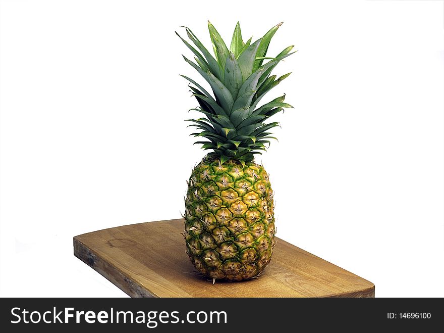 Pineapple on the kitchen wood isolated