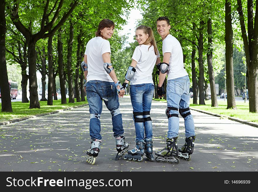 Three young scooters stand having turned back in park