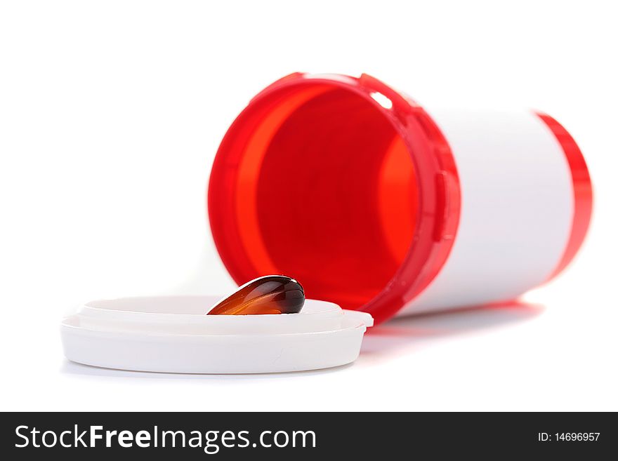 Tablet of brown colour in a cover of the empty container for medicines.