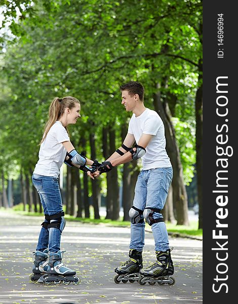 The young couple goes for a drive on rollers. The young couple goes for a drive on rollers