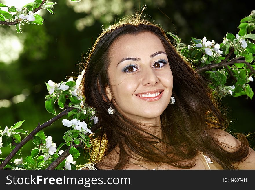 The smiling nice girl in greens of trees. The smiling nice girl in greens of trees