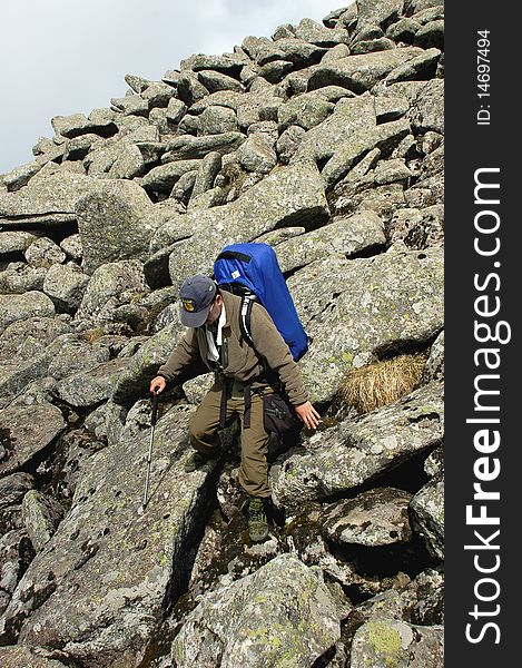 A backpacker trekking in the sea of rocks. A backpacker trekking in the sea of rocks