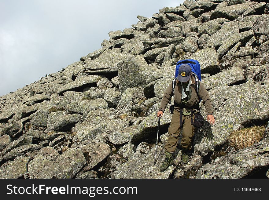 A backpacker trekking in the sea of rocks. A backpacker trekking in the sea of rocks