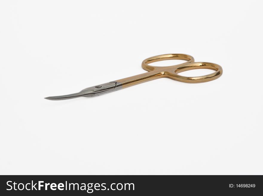 Manicure scissors lying on a white background