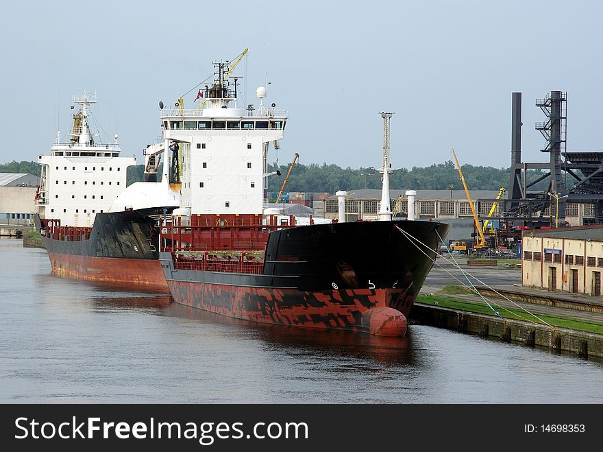 Two ships moored near embankment