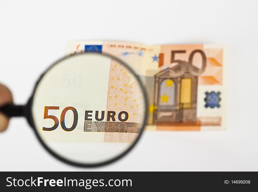 Fifty  euro with magnifying glass on white background. Fifty  euro with magnifying glass on white background