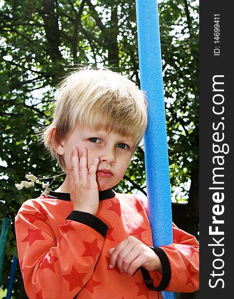 Tough Boy standing with a straw in his mouth. Tough Boy standing with a straw in his mouth