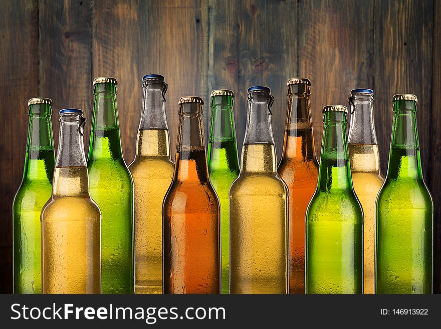 Group of cold wet beer bottles on the grunge background