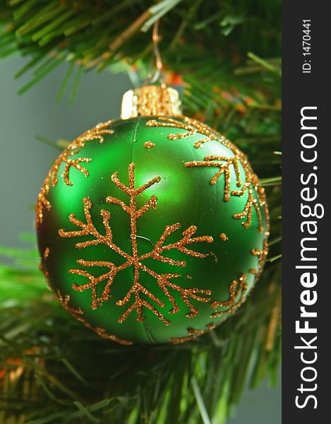 Green ornament with gold snowflake pattern