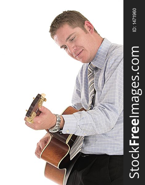 Businessman relaxing playing his old guitar over white. Businessman relaxing playing his old guitar over white