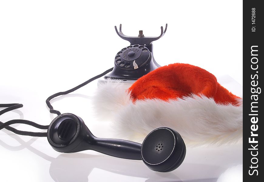 Red santa claus hats and old telephone