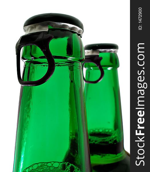 Upper part of two beer bottles isolated over white background. Upper part of two beer bottles isolated over white background