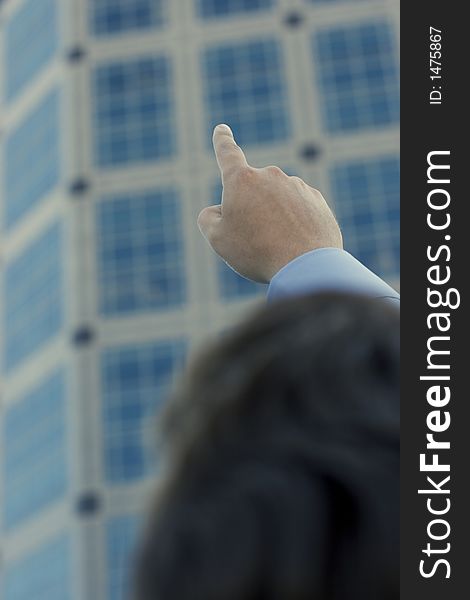 Businessman raising and pointing his finger towards the sky as a new standard. Businessman raising and pointing his finger towards the sky as a new standard