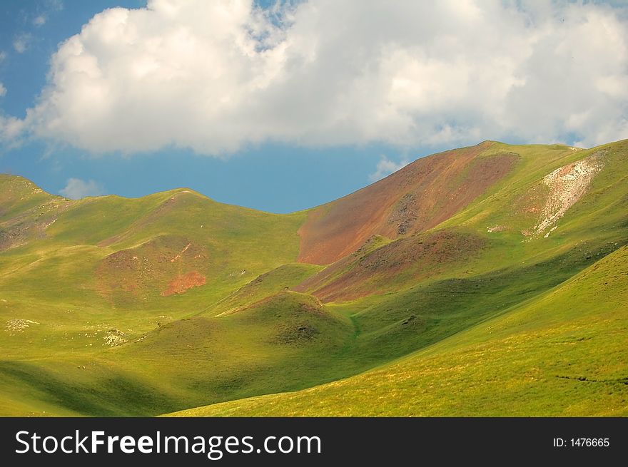 Pasture and cloud shadows in Pyrenees mountains, France