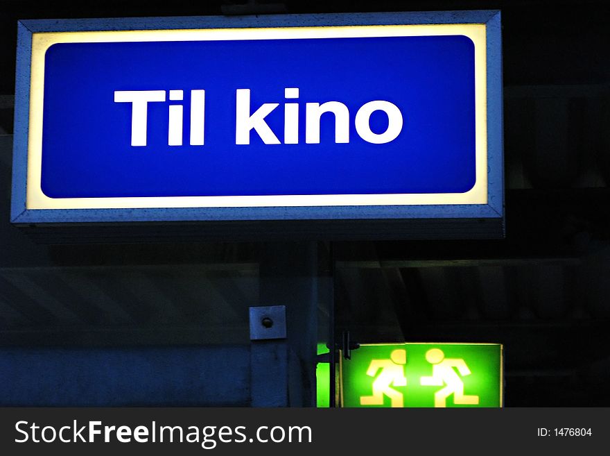 An illuminated sign, showing the way to the cinema,Norwegian text. An illuminated sign, showing the way to the cinema,Norwegian text