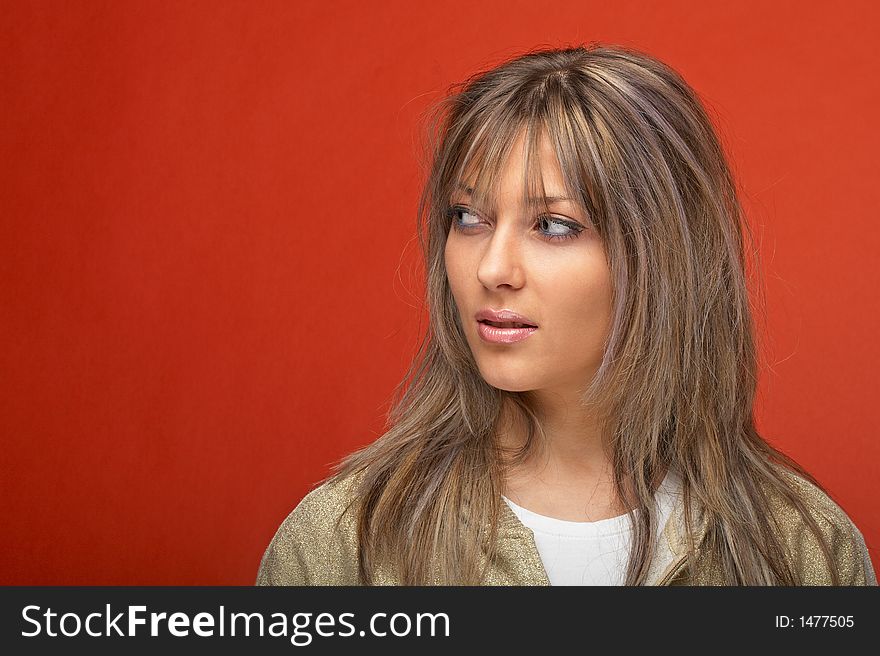 young woman over orange background with a look