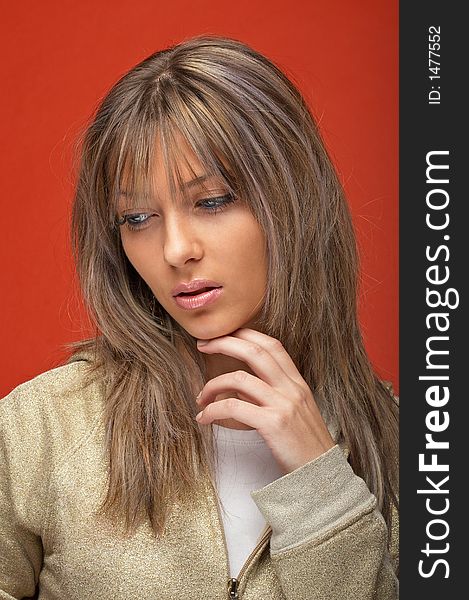 young woman over orange background with a look