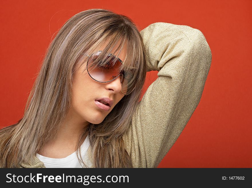 young woman over orange background with a look